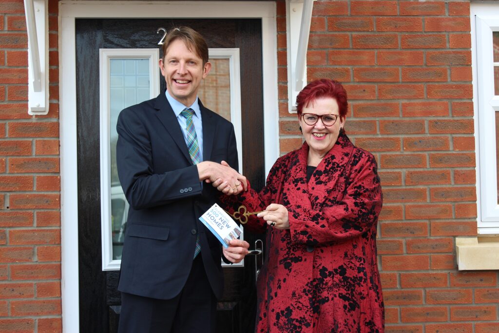 Cllr Sarah Allen receiving the key to the 500th new council property under Labour's local scheme